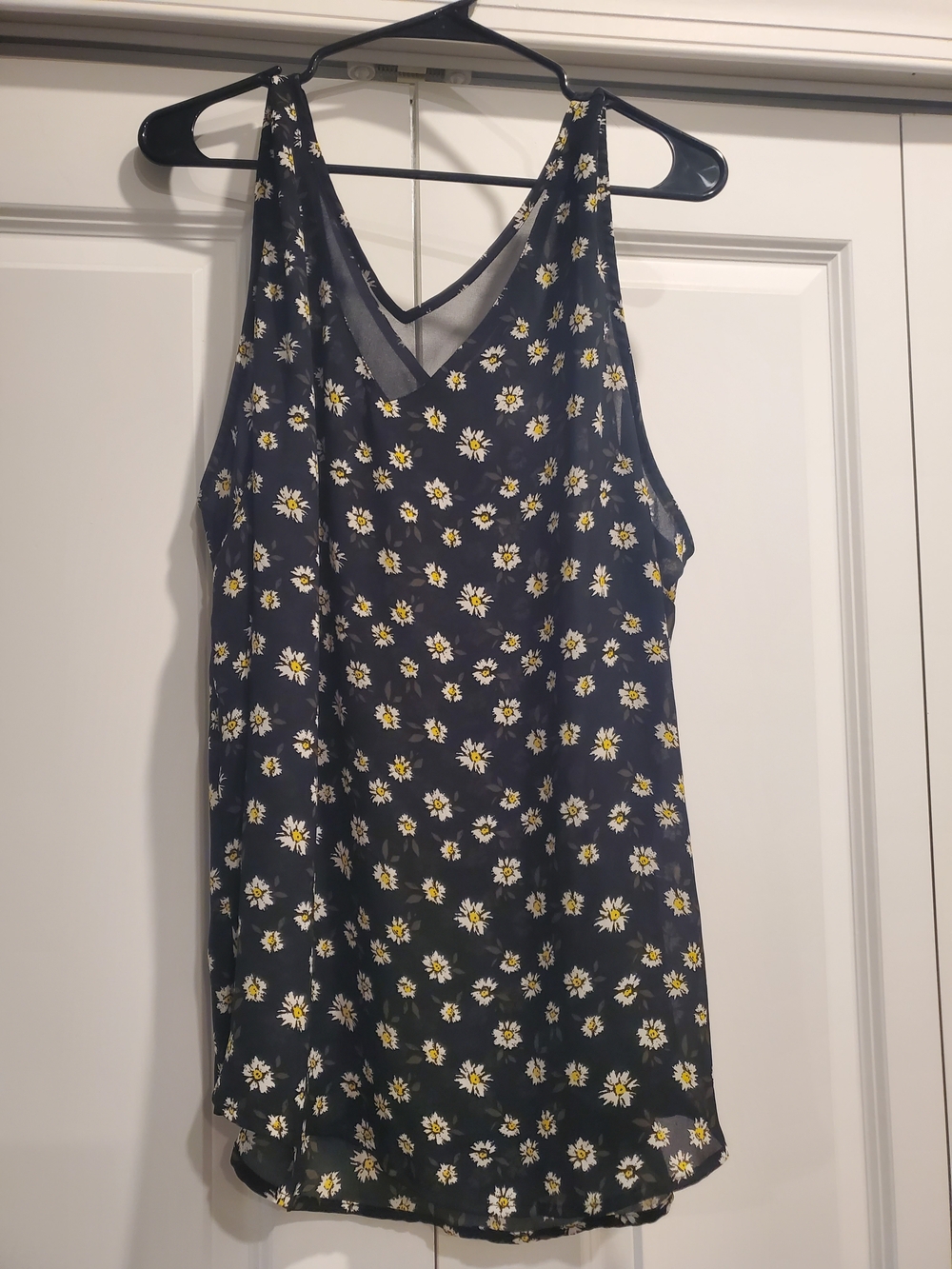 Madison Grey black sleeveless tank top blouse featuring a white and yellow daisy